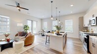 Located in Austin, TX, this well-appointed 2-bedroom, 2-bathroom single-floor residence offers a thoughtfully designed open-concept layout that seamlessly connects the living, dining, and kitchen areas. Light wood-style flooring runs throughout, lending a warm and cohesive feel to the entire space.

The kitchen is a standout feature, showcasing two-tone cabinetry with matte black hardware, quartz countertops, a tile backsplash, a gas range, and a central island with pendant lighting — ideal for both cooking and casual entertaining. The dining area sits adjacent, bathed in natural light from large windows and French doors that open to an outdoor view.

The living area is bright and airy, with multiple windows framing views of the surrounding neighborhood. A clean-lined hallway connects the private quarters, where both bedrooms offer generous proportions, large windows, and dedicated closet space with built-in shelving and hanging rods. The primary bedroom is particularly spacious and is complemented by an en-suite bathroom featuring a glass-enclosed walk-in shower, modern vanity, and ceiling fan. The second bathroom mirrors the same contemporary finishes. Two closets provide ample storage throughout the residence.