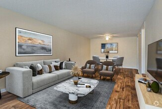 Step into spacious living rooms designed with large windows and versatile color palettes, ready to complement your personal style. - Palatka Oaks Apartments