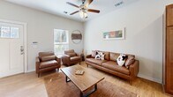 Located in Albuquerque, NM, this two-story, 4-bedroom, 6-bathroom home offers a thoughtfully designed layout spread evenly across two floors. The main level features an open-concept kitchen and living area with warm wood cabinetry, granite countertops, stainless steel appliances, and a central island with bar seating. Light wood flooring flows throughout, complemented by neutral walls that enhance the bright, airy atmosphere. The living room provides a comfortable gathering space with a ceiling fan and natural light from large windows. A dedicated office on the upper level features carpeted flooring, a natural light-filled window, and ample space for a full workstation setup. The four bedrooms are generously sized, each with carpet flooring, natural light, and closet access — one bedroom is notably well-suited as a nursery or child's room. The six bathrooms include tiled flooring and combination tub/shower configurations. Additional highlights include four closets for storage, two staircases connecting the floors, and two hallways ensuring smooth circulation throughout. The home's consistent neutral palette and clean architectural lines create a calm, functional living environment suitable for a variety of needs.