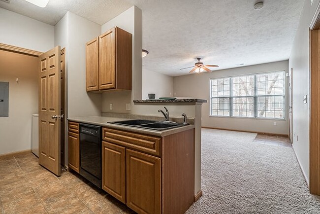 Our Canary floor plan has a spacious kitchen with a breakfast bar. - Stone Creek Villas