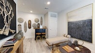 Located in Georgetown, TX, this multi-level 2-bedroom, 2-bathroom home offers a well-organized layout spread across three floors. The entry level provides a welcoming transition into the space, with light wood-style flooring and a secondary living area that offers a quiet retreat. Stairs lead to the main living floor, where an open-concept design seamlessly connects the kitchen, dining room, and living room. The kitchen features granite countertops, white cabinetry, stainless steel appliances, and a central island with a sink. The dining area is bathed in natural light from large windows with outdoor views, complemented by rich olive-toned walls and hardwood-style flooring. The living room is bright and airy, with a ceiling fan, multiple windows, and ample space for comfortable seating. The upper floor houses both bedrooms, each with plush carpet, natural light, and generous proportions. The primary bedroom provides a serene retreat. Both bathrooms are finished with granite-topped vanities, tub-shower combinations, and wood-style tile flooring, offering a clean and cohesive aesthetic throughout the home.