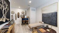 Located in Georgetown, TX, this multi-level 2-bedroom, 2-bathroom home offers a well-organized layout spread across three floors. The entry level provides a welcoming transition into the space, with light wood-style flooring and a secondary living area that offers a quiet retreat. Stairs lead to the main living floor, where an open-concept design seamlessly connects the kitchen, dining room, and living room. The kitchen features granite countertops, white cabinetry, stainless steel appliances, and a central island with a sink. The dining area is bathed in natural light from large windows with outdoor views, complemented by rich olive-toned walls and hardwood-style flooring. The living room is bright and airy, with a ceiling fan, multiple windows, and ample space for comfortable seating. The upper floor houses both bedrooms, each with plush carpet, natural light, and generous proportions. The primary bedroom provides a serene retreat. Both bathrooms are finished with granite-topped vanities, tub-shower combinations, and wood-style tile flooring, offering a clean and cohesive aesthetic throughout the home.