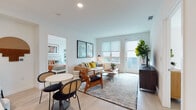 Located at 310 Del Sol Dr in San Diego's Mission Valley neighborhood, this single-story residence offers a thoughtfully designed open floor plan with contemporary finishes and abundant natural light throughout. Light-toned hardwood-style flooring flows seamlessly across the main living areas, creating a cohesive and airy feel.

The living room is generously proportioned, featuring large windows with roller shades that invite natural light, and direct access to an outdoor area through a glass door. A dedicated dining space adjacent to the living area provides a functional layout ideal for entertaining.

The kitchen is a standout feature, outfitted with flat-front gray cabinetry, a mosaic tile backsplash, stainless steel appliances including a gas range and dishwasher, and a wine refrigerator. A large peninsula with quartz countertops offers additional seating and workspace.

Both bedrooms are well-sized with large windows that frame outdoor views and allow generous light. The primary bedroom includes an en-suite bathroom with a clean, all-white design, a wide vanity with undermount sink, and a shower. A second full bathroom mirrors the same minimalist aesthetic. A stacked in-unit washer and dryer adds everyday convenience, completing this well-appointed San Diego residence.