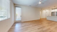 Located at 11821 Skylark Cir in Whittier, CA, this single-story, 3-bedroom, 2-bathroom home offers a well-designed layout with modern finishes throughout. The open-concept kitchen and living area serves as the heart of the home, featuring light wood-look flooring, a large central island with quartz countertops, white shaker cabinetry, a subway tile backsplash, stainless steel appliances including a gas range, microwave, and refrigerator, and elegant pendant lighting overhead. The adjoining living room is bright and airy, with natural light streaming through large windows and a ceiling fan adding comfort. The three bedrooms are carpeted for warmth and comfort, each equipped with ceiling fans and ample closet space, including a dedicated walk-in closet with built-in shelving and hanging rods. The two bathrooms are finished in a clean, contemporary style with wood-look flooring, white cabinetry, quartz vanity tops, and backlit mirrors. The overall aesthetic of the home is crisp and modern, with a neutral color palette of whites and warm beiges that creates a bright, welcoming atmosphere throughout every room.