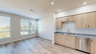 Located at 580 Media Place in Sacramento, CA, this well-appointed one-bedroom, one-bathroom unit offers a thoughtfully designed open-concept layout. The kitchen and living area flow seamlessly together, anchored by light wood cabinetry, granite-look countertops, and a full suite of stainless steel appliances including a refrigerator, electric range, dishwasher, and microwave. Recessed lighting illuminates the kitchen, while light-toned luxury vinyl plank flooring extends throughout the main living areas, contributing to a clean, contemporary aesthetic. A wall-mounted mini-split unit provides efficient climate control in both the living area and bedroom. The living room benefits from large windows fitted with horizontal blinds, inviting generous natural light and views of surrounding greenery. The bedroom features plush carpeting, dual windows with outdoor views, and a closet, while an adjoining door provides direct access to the bathroom. The bathroom is finished with matching light wood cabinetry, granite-look countertops, a large mirror, and a tub/shower combination with tiled surround. Throughout the unit, neutral wall tones, crisp white trim, and consistent finishes create a cohesive, modern feel that is both functional and inviting.