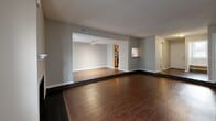 Located in Memphis, TN, this two-story home offers three bedrooms and three bathrooms across two well-proportioned floors. The main level features a spacious living room with rich dark hardwood flooring, a classic fireplace, and generous natural light from large windows and sliding glass doors. Adjacent to the living area, the galley-style kitchen is well-appointed with warm wood cabinetry, granite-style countertops, a mosaic tile backsplash, stainless steel appliances, and a double sink — all opening toward the living space for a connected feel. A dedicated closet and additional storage areas complement the first floor's layout. The second floor houses the bedrooms, each carpeted in neutral tones and featuring built-in closets with bifold doors. The spacious primary bedroom includes a walk-in closet with hardwood flooring and built-in hanging rods. The three bathrooms are cleanly finished with white tile tub-and-shower combinations, wood-tone flooring, and warm wood vanities with granite countertops. Neutral gray walls and textured ceilings are consistent throughout, creating a cohesive and understated aesthetic. Two staircases and connecting hallways ensure smooth circulation across both levels of this functional and comfortable home.