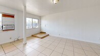 Located at 695 Plaza Ave in Sacramento, CA, this single-story, one-bedroom, one-bathroom unit offers a practical and efficient layout across its single floor. Light-toned ceramic tile flooring runs consistently throughout the entire space, creating a cohesive and easy-to-maintain interior.

The open living area is bright and airy, featuring a large window that allows natural light to fill the room and provides outdoor views of surrounding greenery. A decorative glass-paneled door adds a subtle design detail to the living space. Entry to the unit is through a raised front door, with a small step-up landing that transitions into the main living area.

The kitchen and living room share an open-concept arrangement, with the kitchen positioned along one wall and defined by a structural column. The kitchen features white cabinetry with ample storage, a gas range, a single-basin sink, and a full-size refrigerator, keeping the space clean and functional.

The bedroom is a comfortable size, equipped with a sliding double-door closet for storage and a window that brings in natural light and outdoor views. The full bathroom includes a tiled tub-and-shower combination with floor-to-ceiling tile surround and chrome fixtures. A hallway connects the main living areas, completing this well-organized and straightforward floor plan.