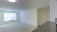 Located at 53 Sand Pit Rd in Danbury, Connecticut, this single-floor space offers a straightforward and functional layout designed for comfortable everyday living. The interior is finished with neutral, light-toned walls that create a bright and airy atmosphere throughout. The main living area is open and generously proportioned, providing a flexible space that can be arranged to suit a variety of needs. Carpeted flooring runs through the living space, adding warmth underfoot, while a window along one wall allows natural light to filter in, enhancing the sense of openness. The ceiling is smooth and well-maintained, contributing to the clean, move-in ready condition of the unit. A doorway off the main area leads to additional spaces within the floor plan. The overall design is simple and uncluttered, offering a neutral canvas that is easy to personalize. The space is well-suited for those seeking a practical and accessible single-level living environment in the Danbury area of Connecticut.