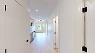 Located in the sought-after neighbourhood of Bankview in SW Calgary, this unit at 2318 15 St SW offers a functional and modern layout across a single floor. The interior features light hardwood-style flooring throughout, crisp white walls, and a clean, contemporary aesthetic that creates a bright and cohesive feel from room to room.

The unit includes three bedrooms, each designed with simplicity in mind. The primary bedroom provides a comfortable retreat with a sliding double-door closet and black hardware accents. The secondary bedrooms are finished with the same light flooring and neutral tones, with at least one room featuring a window that draws in natural light and offers views of the surrounding neighbourhood.

Two well-appointed bathrooms serve the unit. The main bathroom includes a soaker tub with a glass panel enclosure and large-format marble-style tile, offering a clean and spa-like atmosphere. The second bathroom features a walk-in glass shower with a sleek black-framed sliding door and modern fixtures. Both bathrooms maintain a consistent modern design language.

A hallway connects the rooms efficiently, with built-in storage and clean sightlines throughout. The unit also includes a private balcony with open views of the surrounding Calgary skyline and neighbourhood rooftops, adding an outdoor dimension to the living space.