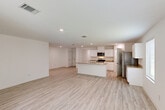Located at 16625 Poe Ave in Baton Rouge, Louisiana, this single-story, 5-bedroom, 4-bathroom home offers a well-designed layout with a clean, modern aesthetic throughout. Light wood-look flooring flows seamlessly across the entire interior, complemented by crisp white walls and recessed lighting that create a bright, airy atmosphere.

At the heart of the home is an expansive open-concept living, dining, and kitchen area. The kitchen is a standout feature, showcasing white shaker-style cabinetry, granite countertops, stainless steel appliances — including a range, microwave, and refrigerator — and a central island with a sink, ideal for cooking and entertaining. A dedicated pantry provides additional storage.

The five bedrooms are well-proportioned, with the generously sized primary bedroom benefiting from multiple windows that invite abundant natural light. The home includes an impressive eight closets in total, ensuring exceptional storage throughout. The four bathrooms are finished with granite-topped vanities and tub/shower combinations.

Additional highlights include a dedicated laundry room equipped with a full-size washer and dryer, a spacious attached garage with an automatic opener and electrical panel access, and a patio for outdoor enjoyment. Three hallways connect the home's rooms efficiently, rounding out this functional and move-in-ready Baton Rouge residence.