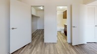 Located at 3708 S Douglas Ave in Oklahoma City, OK, this one-bedroom, one-bathroom apartment is a single-floor unit designed for comfortable, everyday living. Throughout the space, durable wood-look plank flooring provides a warm, cohesive aesthetic that ties each room together.

The living area is bright and open, featuring neutral white walls and a large window fitted with blinds that invites ample natural light while maintaining privacy. A front entry door is conveniently positioned adjacent to this window, offering easy access and a welcoming entry point.

The kitchen is efficiently laid out with rich, dark wood cabinetry, a sink with modern fixtures, and a dishwasher, providing all the essentials in a compact and well-organized space. A louvered closet door nearby adds practical storage within the main living area.

The bedroom connects directly to both a generously sized walk-in closet with built-in shelving and a full bathroom. The bathroom is well-appointed with dark wood cabinetry, a white countertop vanity, a full soaking tub with tiled surround, and wood-look flooring that continues the design theme from the rest of the unit.

The textured ceilings and clean white walls throughout contribute to a bright, neutral atmosphere, making this a move-in ready space suited for a range of lifestyles.