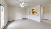 Located at 43001 Thoroughgood Dr in Chantilly, VA, this single-floor, 2-bedroom, 2-bathroom residence offers a well-organized and efficiently designed layout. The spacious living room serves as the heart of the home, featuring plush carpeting, a ceiling fan with light fixture, and a pass-through opening to the kitchen that enhances the open feel. A French-style door leads to an outdoor area, while an adjacent window fills the room with natural light.

The galley-style kitchen is thoughtfully appointed with warm wood-toned cabinetry, white appliances including an electric range, light stone countertops, a stainless steel sink, and wood-look flooring. A dedicated pantry area with open shelving adds valuable storage.

Both bedrooms are generously sized with soft carpeting and large corner or double windows that invite ample natural light and outdoor views. The primary bedroom offers a comfortable footprint and includes a closet. Each full bathroom is outfitted with a tub/shower combination, wood-look tile flooring, and clean white finishes, providing a functional and tidy space. Two hallways and additional closets contribute to practical storage throughout. The overall ambiance is bright, neutral, and move-in ready.