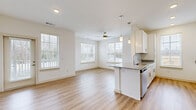 This contemporary 1020 square foot home offers a thoughtfully designed living space across a single floor. The property boasts two bedrooms, including a spacious 180 square foot primary bedroom, and two full bathrooms. The open-concept layout seamlessly integrates the kitchen and living areas, creating a fluid and inviting atmosphere.

The interior is characterized by its bright and airy ambiance, achieved through large windows that allow ample natural light to flood the rooms. The flooring alternates between warm wood tones in the main living areas and plush carpeting in the bedrooms, adding comfort and visual interest.

The kitchen is a highlight, featuring sleek white cabinetry, granite countertops, and stainless steel appliances. A central island with a sink provides additional workspace and casual dining options. The bathrooms are equally impressive, with modern fixtures, granite vanity tops, and a mix of tiled and wood-look flooring.

Throughout the home, recessed lighting and ceiling fans contribute to the overall modern aesthetic while ensuring optimal illumination and comfort. The neutral color palette, predominantly in whites and light tones, creates a clean and versatile canvas for various decor styles.

Storage is well-considered, with built-in closets in the bedrooms and ample cabinet space in the kitchen and bathrooms. The property's layout efficiently utilizes the available space, offering a harmonious balance between openness and privacy.