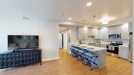 Located at 1965 East Mountain View Avenue in Flagstaff, Arizona, this single-floor, 2-bedroom, 2-bathroom residence offers a thoughtfully designed layout that balances comfort and functionality. Light wood flooring flows throughout, complementing the clean, neutral color palette that defines the space.

The open-concept living area connects seamlessly to the kitchen, which features gray shaker-style cabinetry, white quartz countertops, stainless steel appliances, and a spacious island with bar seating illuminated by stylish pendant lighting. A hallway leads to both bedrooms, each offering a tray ceiling detail that adds architectural interest. The primary bedroom is a comfortable retreat with direct access to its own bathroom. Both bathrooms are well-finished, featuring shaker vanities with white countertops and a shower-tub combination with sliding glass doors.

The second bedroom is versatile and well-suited as a home office or guest room. Four closets throughout the residence provide generous storage, including a dedicated utility room. Large windows in the living area admit abundant natural light and offer views of the surrounding neighborhood. The overall ambiance is clean, modern, and inviting — a well-organized home suited for everyday living in the Flagstaff community.