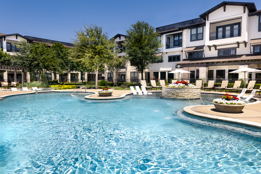 Pool includes expansive tanning area and water feature - StoneLedge