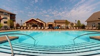 Located at 277 Bend Blvd in Westerville, Ohio, this single-floor residence is part of a well-appointed community that offers an impressive array of shared amenities. The community's centerpiece is a generously sized outdoor swimming pool with crystal-clear water, surrounded by a spacious sundeck lined with lounge chairs — ideal for relaxing on warm days. A handsome covered pavilion with wood timber accents anchors the pool area and connects to the main community building, which features a warm, craftsman-inspired exterior with neutral siding and dark-trimmed windows. The overall outdoor environment is open and airy, set beneath expansive Ohio skies. The interior of the unit is laid out across a single level, offering a straightforward and accessible floor plan. Windows fitted with horizontal blinds allow residents to control natural light throughout the interior spaces. While the interior images reflect low-light conditions, the unit appears to include defined living areas with consistent flooring and a functional layout. The combination of community-oriented outdoor amenities and a practical single-level interior makes this property a well-rounded residential option in the Westerville area.