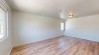 Located at 14243 Rodeo Dr in Victorville, CA, this single-floor, 2-bedroom, 2-bathroom home offers a practical and well-organized layout. The entrance leads into a bright living area featuring light-toned wood-look laminate flooring and white walls that create a clean, airy atmosphere. Natural light filters in through windows, enhancing the open feel of the space.

The kitchen is equipped with warm wood cabinetry, dark laminate countertops, a white gas range, and a sink, all set on neutral tile flooring. Ample cabinet storage lines the walls, providing generous space for organization.

Both bedrooms are carpeted and receive natural light through windows. The primary bedroom includes a sliding glass door that opens onto a private balcony with outdoor views, while the second bedroom features a built-in closet. Each room offers a comfortable, quiet retreat.

The two bathrooms are finished with tile flooring. One bathroom includes a full tub-shower combination with white tile surround and a vanity with a granite-style countertop. The hallway connecting the rooms is clean and efficiently designed, with tile flooring and access to the secondary bathroom vanity area.

Overall, this home presents a straightforward, functional design with consistent finishes throughout.
