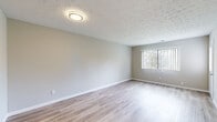 Located at 370 St Andrews Dr in Cincinnati, Ohio, this single-floor home offers a clean, updated interior with a cohesive neutral color palette and a mix of light hardwood-style flooring and plush carpeting throughout. The spacious living area features light wood-style flooring, a textured ceiling, and a large window fitted with vertical blinds that invites natural light into the room. A well-lit hallway connects the main living space to the private areas of the home, creating a smooth, functional flow. The kitchen is outfitted with white cabinetry, marble-look countertops, a classic subway tile backsplash, and stainless steel appliances including a refrigerator, over-the-range microwave, and an electric range. The bedrooms are carpeted and generously proportioned, with one room featuring sliding glass doors that open to an outdoor view, while others include windows with blinds for natural light and privacy. The bathrooms are neatly appointed, with one featuring a white vanity, integrated sink, matte black fixtures, and a mirrored medicine cabinet, and another including a full tub-shower combination. Throughout, the home presents a move-in ready, well-maintained environment with consistent finishes and a bright, welcoming ambiance.