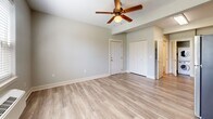 Located at 18181 Webster Rd in Gladstone, Oregon, this efficiently designed studio unit makes excellent use of its single-floor layout. Light-toned luxury vinyl plank flooring flows seamlessly throughout the entire space, creating a cohesive and easy-to-maintain interior.

The kitchen is a standout feature, outfitted with warm honey-toned wood cabinetry, granite-look countertops, and a full suite of stainless steel appliances including a refrigerator, electric range, microwave, and dishwasher. A double-basin sink with a modern matte black faucet adds a contemporary touch. Conveniently tucked just off the kitchen is a dedicated in-unit laundry closet housing a stacked washer and dryer.

The main living area is open and airy, featuring neutral gray walls, clean white baseboards, a ceiling fan with integrated lighting, and a closet for additional storage. The space benefits from a raised ceiling detail that adds architectural interest and a sense of openness.

The bathroom is neatly appointed with a wood-toned vanity complemented by granite-look countertops, a well-lit mirror, a standard tub-shower combination, and consistent flooring that ties the space together. The overall ambiance is clean, modern, and functional — well-suited for efficient everyday living.