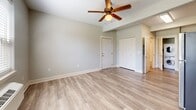 Located at 18181 Webster Rd in Gladstone, Oregon, this efficiently designed studio unit makes excellent use of its single-floor layout. Light-toned luxury vinyl plank flooring flows seamlessly throughout the entire space, creating a cohesive and easy-to-maintain interior.

The kitchen is a standout feature, outfitted with warm honey-toned wood cabinetry, granite-look countertops, and a full suite of stainless steel appliances including a refrigerator, electric range, microwave, and dishwasher. A double-basin sink with a modern matte black faucet adds a contemporary touch. Conveniently tucked just off the kitchen is a dedicated in-unit laundry closet housing a stacked washer and dryer.

The main living area is open and airy, featuring neutral gray walls, clean white baseboards, a ceiling fan with integrated lighting, and a closet for additional storage. The space benefits from a raised ceiling detail that adds architectural interest and a sense of openness.

The bathroom is neatly appointed with a wood-toned vanity complemented by granite-look countertops, a well-lit mirror, a standard tub-shower combination, and consistent flooring that ties the space together. The overall ambiance is clean, modern, and functional — well-suited for efficient everyday living.