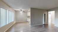 Located at 16211 Parkside Ln in Huntington Beach, CA, this one-bedroom, one-bathroom residence offers a thoughtfully arranged single-floor layout. Wood-look flooring flows consistently throughout, complemented by neutral gray-toned walls and textured ceilings that lend a cohesive, clean aesthetic.

The combined kitchen and living area forms the heart of the home. The kitchen is well-equipped with white cabinetry, granite-look countertops, a stainless steel gas range, dishwasher, and a double-basin sink — all arranged in an efficient galley-style configuration. The adjacent living room benefits from a ceiling fan with light fixture and a large window fitted with vertical blinds, allowing generous natural light to fill the space.

The spacious primary bedroom features sliding glass doors that open directly to a private outdoor patio area, bringing in additional natural light and outdoor access. The room offers ample space for furnishings and connects conveniently to the hallway.

The bathroom is clean and functional, featuring white cabinetry with brushed nickel hardware, a granite-look countertop with an undermount sink, a tub/shower combo with white tile surround, and a window for natural ventilation. A hallway connects all rooms, completing this practical and well-maintained layout.