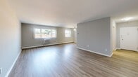 Located at 6901 Old York Rd in Philadelphia's 19126 neighborhood, this 2-bedroom, 2-bathroom unit offers a well-organized, single-floor layout designed for comfortable living. The open living room is bright and welcoming, featuring light-toned luxury vinyl plank flooring, soft neutral gray walls, large windows that invite natural light, and a ceiling fan overhead. A wall-mounted HVAC unit and baseboard heating provide year-round climate control throughout the space. The galley-style kitchen is outfitted with warm wood cabinetry, white appliances including a gas range and built-in microwave, tile backsplash, and light tile flooring, offering an efficient and functional cooking space. Both bedrooms are carpeted and finished with the same neutral palette. The generously sized primary bedroom features an expansive wall of bifold closet doors, a window, and baseboard heating. The second bedroom benefits from dual windows, filling the room with natural light. A hallway connects the bedrooms to the two bathrooms, one of which features white subway tile wainscoting, a vanity with under-sink cabinet storage, a lighted mirror, and a glass-enclosed shower. The clean, understated aesthetic throughout makes this a move-in-ready home.