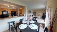 Located at 3630 East 51st Avenue in Spokane, Washington, this single-floor residence offers a well-organized and functional layout throughout. The open-concept design connects the kitchen, dining area, and living room, creating a cohesive and comfortable living space. The kitchen features warm honey-toned cabinetry, dark appliances including a refrigerator, dishwasher, and range, a double basin sink, and tile flooring. A pass-through counter connects the kitchen to the dining area, which is brightened by a large window overlooking greenery and includes a ceiling light fixture. The living room is carpeted and spacious, featuring a sliding glass door that opens to a private patio, allowing natural light to fill the room. The bedrooms are carpeted and well-lit with natural light from windows that frame outdoor views of surrounding trees. Each room offers a calm, neutral palette. Two bathrooms serve the residence: one features a tub-shower combination, a single vanity with ample counter space, and tile flooring, while the second includes a walk-in glass-enclosed shower, a vanity, and matching tile flooring. Overall, the space presents a practical and inviting atmosphere well-suited for comfortable everyday living.