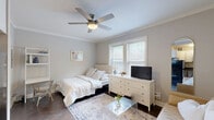 Located in Chicago's desirable Lincoln Park neighborhood, this efficient one-bedroom, one-bathroom unit on W Wrightwood Avenue makes excellent use of its intimate footprint. The main living area seamlessly blends sleeping and lounging spaces, featuring warm dark hardwood floors, soft neutral-gray walls, and crown molding that adds a classic architectural touch. A ceiling fan provides comfort overhead, while two large windows flood the room with natural light and offer views of surrounding greenery. The bedroom area includes a double closet and a cozy nook with a ladder desk, maintaining a clean, airy aesthetic throughout. The compact kitchen is thoughtfully appointed with white shaker cabinetry, a tile subway backsplash, dark countertops, and a full suite of stainless steel appliances — including a range, over-the-range microwave, dishwasher, and refrigerator — maximizing both function and style in a small footprint. Dark hardwood flooring runs consistently through the space, tying each area together cohesively. The overall ambiance is light, calm, and carefully curated, making this Lincoln Park unit a practical and stylish urban retreat.