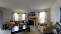 Located at 700 Vista Dr in Gahanna, Ohio, this multi-story home spans three floors, offering a generous and versatile layout suited for comfortable living. The living room serves as a welcoming centerpiece, anchored by a classic wood-trimmed fireplace with a tile surround that adds warmth and character to the space. Plush wall-to-wall carpeting runs throughout, complementing the neutral tones of the walls and décor. Multiple windows dressed with light, flowing curtains allow natural light to fill the room, creating a bright and airy atmosphere. The layout accommodates both relaxed seating arrangements and tasteful decorative touches, including framed wall art and coordinated furnishings. The overall ambiance of the home is warm and inviting, with a traditional aesthetic that balances comfort and style. Spread across three floors, the home provides ample room for living, sleeping, and additional functional spaces, making it a practical and appealing residence in the established Gahanna community.