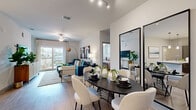 Located in the sought-after Lakewood Ranch community of Sarasota, FL, this well-appointed 3-bedroom, 2-bathroom single-story home offers a thoughtfully designed open-concept layout. Light wood-style flooring flows throughout the main living areas, connecting the kitchen, dining, and living room into a cohesive, airy space bathed in natural light.

The contemporary kitchen is a standout feature, boasting dark wood cabinetry, a mosaic tile backsplash, stainless steel appliances, and a generous white quartz island with bar seating and pendant lighting — ideal for both everyday dining and entertaining. The open living and dining area offers ample room for relaxation, with a ceiling fan overhead and sliding glass doors that lead to a private balcony.

The primary bedroom is a comfortable retreat, featuring plush carpeting, large windows with abundant natural light, and a spacious walk-in closet with built-in shelving. The bathrooms are finished with modern wood-tone vanities, white quartz countertops, and full tub and shower combinations with clean tile surrounds.

Two additional bedrooms provide flexible space for guests or a home office. Two closets offer generous storage throughout. The overall ambiance is clean, contemporary, and welcoming — a well-rounded home in a premier Florida location.