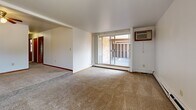 Located at 5634 W Oklahoma Ave in Milwaukee, WI, this single-floor unit offers a well-organized layout comprising one bedroom, three bathrooms, a combined kitchen and living room, and a dedicated closet. The living room is generously proportioned, featuring wall-to-wall carpeting, a ceiling fan with light fixture, baseboard heating, and a sliding glass door that opens to a private enclosed patio — a distinctive outdoor space framed by brick walls and a partially open roof, ideal for fresh air and natural light. An additional carpeted room with vertical blinds and a wall-mounted air conditioning unit provides versatile space. The kitchen is functional and efficient, equipped with warm oak cabinetry, granite-style laminate countertops, a double-basin sink, and a full-size refrigerator, with light vinyl flooring throughout. The bathrooms are clean and practical; one features a full-width vanity with oak cabinetry and a stone-patterned countertop, while another includes a tub-shower combo with mosaic tile accenting. The bedroom is comfortably sized, carpeted, and naturally lit through a window with vertical blinds and baseboard heating below. Overall, the unit presents a straightforward, functional aesthetic well-suited for comfortable everyday living.