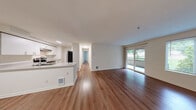 Located at 4250 W Lake Sammamish Pkwy NE in Redmond, WA, this well-designed 2-bedroom, 2-bathroom residence offers a comfortable and functional single-floor layout. The open-concept living, dining, and kitchen area serves as the heart of the home, featuring warm hardwood-style flooring that flows throughout. Large sliding glass doors lead to a private balcony, filling the living space with natural light and offering pleasant views of the surrounding greenery.

The kitchen is outfitted with white cabinetry, a light-toned countertop with an undermount stainless steel sink, a range, and a full-size refrigerator, all framed by under-cabinet lighting and a clean, modern aesthetic. The living and dining areas provide generous room for entertaining and everyday living.

Both bedrooms are well-proportioned and bright, with windows overlooking lush outdoor scenery and baseboard heating. The spacious primary bedroom includes ample closet space. With six total closets throughout the residence, storage is a notable strength of this layout. Both bathrooms feature full soaking tubs with chrome fixtures in a clean, neutral finish. The combination of practical design, abundant storage, and a desirable Redmond location makes this a highly functional and inviting home.