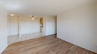 Located at 3161 W Ball Rd in Anaheim, California, this single-floor residence offers a clean, functional layout with a bright and neutral aesthetic throughout. Light wood-style flooring runs through the main living areas and bedrooms, complementing the crisp white walls and textured ceilings found in much of the unit.

The open living area is generously sized and benefits from ample natural light streaming through vertical-blind sliding glass doors that lead directly to a private balcony — ideal for outdoor relaxation. A ceiling fan and wall-mounted HVAC unit provide year-round comfort.

The galley-style kitchen is efficiently designed, featuring warm oak cabinetry, granite-patterned countertops, a stainless steel sink, and a white electric range with overhead ventilation. Light tile flooring ties the kitchen space together seamlessly.

The bedrooms are well-proportioned and sun-filled, each with light wood flooring and textured ceilings. One bedroom includes mirrored sliding closet doors, offering both storage and a sense of added space.

The bathrooms are clean and functional, finished with granite-topped vanities, large mirrors, tile flooring, and full shower-tub combinations with chrome fixtures. The overall ambiance of the unit is bright, neutral, and move-in ready, offering a comfortable living environment in a convenient Anaheim location.