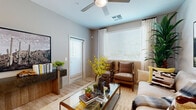 Located in Phoenix, AZ, this well-appointed one-bedroom, one-bathroom residence offers a thoughtfully designed single-floor layout that maximizes every square foot. Light wood-style flooring flows consistently throughout, lending warmth and cohesion to the entire space.

The open-concept living and dining area is bright and inviting, featuring large windows with blinds and sheer curtains that allow generous natural light. A ceiling fan adds comfort overhead, while a private exterior door provides convenient outdoor access directly from the living room.

The dedicated dining nook offers a cozy setting with its own defined space, ideal for everyday meals or entertaining. Adjacent to it, the kitchen stands out with sleek gray shaker-style cabinetry, a white quartz-topped island, stainless steel appliances including a French door refrigerator and over-the-range microwave, and a classic tile backsplash — all combining style with functionality.

The primary bedroom is comfortably sized, featuring a sliding glass door that opens to a private outdoor balcony and fills the room with natural light. A dedicated closet provides practical storage.

The bathroom is clean and modern, featuring a full tub-shower combo, light gray cabinetry with a white countertop, and matching wood-style flooring. Every room reflects a consistent, contemporary aesthetic well-suited to the Phoenix lifestyle.