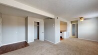 Located in Lexington, Kentucky, this single-floor residence offers a practical and straightforward layout designed for comfortable everyday living. The interior is finished throughout with neutral gray walls and warm beige carpeting, creating a cohesive and understated aesthetic across the living spaces.

The main living area is generously proportioned, featuring a textured ceiling, exposed structural beam detailing, and built-in closet storage. The space flows openly toward a designated kitchen area, which is separated by a partial wall and transition to hardwood-style flooring. The kitchen is equipped with white cabinetry, laminate countertops, a gas range with overhead ventilation, and a stainless sink — offering a functional workspace with ample upper and lower cabinet storage.

The bedrooms are carpeted and well-sized, each featuring dedicated closet space. Natural light enters through windows fitted with blinds, lending a bright and airy quality to the rooms. The full bathroom includes a white tiled tub and shower combination, a toilet, and a clean, utilitarian finish.

The 3D floor plan reveals a compact, efficiently organized layout that maximizes the use of available space throughout. Overall, the residence presents a clean, move-in ready environment suited for a range of occupants.