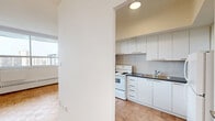 Located on the 16th floor at 263 Dixon Road in Toronto's west end, this one-bedroom, one-bathroom unit offers a well-organized layout across a comfortable single floor. Warm parquet flooring flows consistently throughout the living areas and bedroom, lending a classic character to the space.

The combined kitchen and living room forms the heart of the unit. Large windows span the living area, flooding the space with natural light and framing open city and skyline views. A baseboard heating system runs beneath the windows. The kitchen is separated by a half-wall partition, featuring tile flooring, a white electric range, and tile backsplash, while remaining visually connected to the living area through a pass-through opening.

The bedroom is a well-proportioned private retreat, also benefiting from a large window with expansive outdoor views and baseboard heating. A full-width sliding closet provides generous built-in storage.

The bathroom is clean and functional, featuring a full-size soaker tub with an overhead shower, white subway tile surround, and classic chrome fixtures.

A hallway connects the rooms efficiently, completing this practical and bright unit that makes excellent use of its space in a high-rise setting in Toronto.