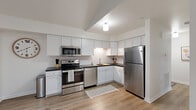 Located at 7008 Erie Rd in Derby, NY, this thoughtfully designed 2-bedroom, 1-bathroom single-floor home offers a clean, modern aesthetic with quality finishes throughout. The open-concept layout seamlessly connects the living room and kitchen, creating a bright and functional living space. Vaulted ceilings in the kitchen area add a sense of architectural interest and openness, while light hardwood-style flooring flows consistently throughout the home.

The kitchen is a standout feature, showcasing crisp white shaker cabinetry, dark contrasting countertops, a classic subway tile backsplash, and a full suite of stainless steel appliances, including a range, over-the-range microwave, dishwasher, and refrigerator. The living room is welcoming and well-lit, with a large window allowing natural light to fill the space.

Both bedrooms are comfortably sized, with the primary bedroom offering a window with natural light and ample room for furnishings. The shared full bathroom is finished with large-format marble-look tile flooring, a grey vanity with white countertop, a wall mirror, and a shower-tub combination. The overall ambiance of the home is fresh, clean, and move-in ready, making it an ideal residence in the Derby area.