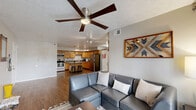 Located at 2053 Willowbrook Dr in West Lafayette, Indiana, this single-story, 4-bedroom, 3-bathroom home offers a well-designed open-concept layout ideal for shared or family living. The combined living and dining area is anchored by warm hardwood-style flooring, a ceiling fan, and a wall-mounted TV, while French doors flood the space with natural light and provide outdoor access. A centrally mounted basketball hoop adds a fun, casual touch to the common area.

The kitchen is fully equipped with stainless steel appliances — including a refrigerator, microwave, and range — complemented by warm wood cabinetry, ample counter space, and a center island with bar seating, all illuminated by pendant lighting and a textured ceiling.

The four bedrooms are comfortably sized, with soft carpeting underfoot and closet access in select rooms. The primary bedroom includes an en-suite area with a vanity space and wood-look flooring. The three bathrooms are clean and functional, featuring tub-shower combinations and wood-style flooring.

Additional highlights include a dedicated utility room, two closets for extra storage, and a cohesive neutral color palette throughout. The textured ceilings and consistent flooring materials tie together the home's practical yet welcoming aesthetic.