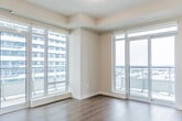 Located at 2530 Eglinton Ave W in Mississauga, this well-designed two-bedroom, two-bathroom unit offers a thoughtful layout across a single floor. The open-concept kitchen and living area serves as the heart of the home, featuring a granite-topped island, stainless steel appliances including a range, microwave, and dishwasher, and sleek white cabinetry that maximizes storage. Warm hardwood-style flooring runs throughout, complementing the bright, neutral palette.

Floor-to-ceiling windows in the living area and bedrooms flood the space with natural light and frame expansive views of the surrounding Mississauga cityscape and beyond. Both bedrooms offer generous proportions, with large windows or sliding glass doors opening to a balcony, providing scenic outdoor views.

The two bathrooms are finished in a clean, modern style. The main bathroom features white subway tile surrounding a full soaker tub and shower, chrome fixtures, and a white vanity. The second bathroom is equally well-appointed, with large-format tile flooring, a white vanity, and a tiled shower area.

Clean lines, contemporary finishes, and abundant natural light define the overall ambiance of this well-appointed unit in the heart of Mississauga.
