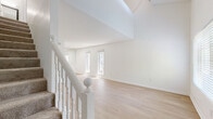 Located at 2800 Paces Ferry Rd SE in Atlanta, GA, this two-story, one-bedroom, one-bathroom residence offers a thoughtfully laid-out floor plan spread across two levels. The main floor features an open living area bathed in natural light from multiple windows, with light-toned hardwood-style flooring and crisp white walls that create a clean, airy atmosphere. A white-railed staircase connects the two levels, adding a classic architectural detail to the space. The kitchen is outfitted with white cabinetry, granite countertops, and stainless steel appliances, including an electric range and over-the-range microwave, delivering both style and functionality. Upstairs, the generously sized primary bedroom is finished with plush carpeting, a ceiling fan, and windows that invite natural light. Two closets provide ample storage throughout the home. The full bathroom features a tub/shower combination enclosed by floor-to-ceiling stone-look tile in rich earthy tones, lending a spa-like quality. Textured ceilings and consistent neutral finishes throughout both floors give this residence a cohesive, move-in-ready feel.