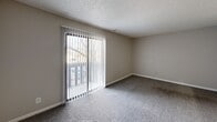 Located at 519 E Marion Rd, Unit 304 in Wichita, KS, this one-bedroom unit offers a functional and comfortable single-floor layout. Neutral-toned walls and plush carpeting throughout create a cohesive, understated aesthetic complemented by textured ceilings and clean white baseboards.

The combined kitchen and living area forms the heart of the unit. The kitchen is equipped with warm oak cabinetry, a white electric range with an overhead exhaust hood, and light countertops — all efficiently arranged for everyday use. The living area flows naturally from the kitchen and features carpet flooring, generous wall space, and a sliding glass door fitted with vertical blinds that opens to a private balcony, allowing natural light to fill the room and providing outdoor views.

The bedroom is a well-proportioned retreat, featuring plush carpet, a window with blinds that brings in soft natural light, and two side-by-side closets with louvered bi-fold doors — offering ample storage. A flush-mount ceiling light fixture provides consistent illumination throughout.

Overall, the unit presents a clean, practical living environment with a neutral palette that offers a versatile canvas for personalization. Its location on the third floor provides elevated outdoor views accessible directly from the living area.