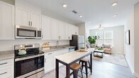 Located at 4121 Concord Creek Place in Richmond, VA, this 1-bedroom, 1-bathroom residence offers a thoughtfully designed open-concept layout that maximizes every square foot. Light-toned luxury vinyl plank flooring flows throughout the main living areas, complementing the clean, contemporary aesthetic of the space.

The kitchen is a standout feature, showcasing floor-to-ceiling white shaker cabinets with matte black hardware, granite countertops, and a full suite of stainless steel appliances including a range, built-in microwave, dishwasher, and refrigerator. A kitchen island with a white countertop provides additional prep space and casual seating, opening seamlessly into the living room.

The living room is bright and welcoming, with large windows that invite natural light and offer outdoor views. A ceiling fan adds to the comfort of the space.

The bedroom is a calm and comfortable retreat, featuring a ceiling fan, windows with natural light, and direct access to the bathroom. The bathroom is well-appointed with white cabinetry, granite countertops, a large mirror with vanity lighting, and dark hardwood-style flooring. A dedicated closet provides practical storage. The overall ambiance is modern, clean, and move-in ready.