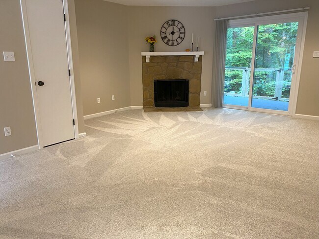 living room with wood-burning fireplace - 7408 Sandy Creek Dr