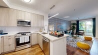 Located at 5710 Crescent Park E in the sought-after Playa Vista neighborhood of Los Angeles, this well-appointed two-bedroom, one-bathroom residence offers a thoughtfully designed open-concept layout across a single floor. Warm hardwood flooring flows throughout, unifying the living, dining, and kitchen areas into a cohesive, inviting space.

The modern kitchen is outfitted with light wood cabinetry, sleek quartz countertops, stainless steel appliances including a gas range, built-in microwave, dishwasher, and french-door refrigerator, plus a peninsula with pendant lighting that connects seamlessly to the living area. The living room is bright and spacious, with sliding glass doors that invite natural light and access to an outdoor area.

The dedicated dining room features elevated windows that allow additional natural light, complementing the room's comfortable proportions. The primary bedroom offers a restful retreat, while the second bedroom features a bold accent wall and large window. The bathroom is finished with large-format tile, a soaking tub with shower, and a wood-toned vanity with ample storage. A stacked in-unit washer and dryer is conveniently located near the entry.