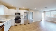 Located in the vibrant Ocean Beach neighborhood of San Diego, this single-story home offers a clean, modern aesthetic with thoughtfully designed living spaces throughout. The open-concept layout seamlessly connects the living area to the kitchen, creating an airy and functional flow ideal for everyday living and entertaining.

The kitchen is well-appointed with white shaker cabinetry, white countertops, and a full suite of stainless steel appliances including a gas range, over-the-range microwave, dishwasher, and a French door refrigerator with an in-door water and ice dispenser. A window above the sink allows natural light to brighten the workspace.

The living area is generously sized, featuring recessed lighting, a neutral color palette, and light-toned luxury vinyl plank flooring that extends throughout the entire home. Bedrooms are comfortable and well-lit, each featuring windows with blinds that frame neighborhood views, and ceiling fans for added comfort.

Two bathrooms serve the home — one featuring a tub-shower combination with sliding glass doors and a white vanity, and the other offering a walk-in glass-enclosed shower, white vanity, and a high window for natural light. Both bathrooms continue the home's consistent modern, clean design. Recessed lighting and neutral tones unify the space with a bright, contemporary character.