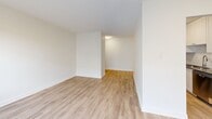 Located at 274-278 Cedar Ave in Richmond Hill, Ontario, this thoughtfully renovated 2-bedroom, 1-bathroom unit offers a clean, modern living experience across a well-utilized single floor. Light wood-tone vinyl flooring flows consistently throughout the space, complementing the bright white walls and creating a cohesive, contemporary aesthetic.

The open living area is bathed in natural light through large windows and a sliding balcony door, leading to a private balcony with views of the surrounding residential complex. The galley-style kitchen is well-appointed with white shaker cabinetry, dark countertops, subway tile backsplash, and stainless steel appliances including a range, microwave, and refrigerator — offering efficient use of space with ample storage.

Both bedrooms are comfortably sized with large windows that allow natural light and baseboard heating for year-round comfort. The primary bedroom includes a built-in sliding door closet, while the second bedroom offers a similarly bright and airy feel.

The bathroom is finished with classic white subway tile surrounding a full soaker tub, accented by chrome fixtures for a clean, timeless look. A hallway connects all rooms efficiently, providing a logical and functional layout throughout the unit.