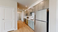 Located at 2226 18th Ave in Longmont, Colorado, this 2-bedroom, 1-bathroom residence offers a thoughtfully designed single-floor layout that maximizes every square foot of living space. Light wood flooring flows consistently throughout, lending a warm, cohesive aesthetic to each room.

The open kitchen and living area serves as the heart of the home. The kitchen is outfitted with gray shaker-style cabinetry extending to the ceiling for ample storage, crisp white quartz countertops, a classic subway tile backsplash, and a full suite of stainless steel appliances including a range, microwave, dishwasher, and refrigerator. Recessed lighting and a clean-lined design make this a highly functional space.

The living room features a glass door and large windows that invite natural light and provide views of the surrounding neighborhood. Both bedrooms are bright and well-proportioned, with windows featuring blinds and light-toned walls that create a calm atmosphere. The primary bedroom includes a double-door closet for generous storage.

The bathroom features tile flooring, a single vanity with quartz countertops and shaker cabinetry, a large mirror, and a tiled walk-in shower. Clean, neutral finishes throughout make this residence move-in ready.
