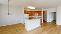 Located at 1055 Cetronia Rd in Breinigsville, PA, this single-floor, 2-bedroom, 3-bathroom home offers a clean, modern aesthetic with a bright and welcoming atmosphere throughout. Light-toned hardwood-style flooring flows consistently across the living spaces, complemented by crisp white walls and trim that create an airy, open feel.

The living room is generously sized, featuring a bank of multiple windows that allow abundant natural light and views of the surrounding neighborhood. Adjacent to it, the dining area includes its own window with outdoor views and a decorative light fixture. The kitchen is well-appointed with warm honey-toned wood cabinetry, light countertops, tile flooring, and a full suite of white appliances including a gas range, over-the-range microwave, and refrigerator.

The spacious primary bedroom offers vaulted ceilings, natural light, and a large walk-in closet with wire shelving. The second bedroom also features hardwood-style flooring, a double-door closet, and ample natural light. All three bathrooms are finished with tile flooring and include tub/shower combinations with accessibility grab bars.

A hallway connects the main living areas to the bedrooms, featuring a classic paneled door design and flush-mount lighting. A dedicated entrance and additional closet round out the practical layout of this well-designed home.