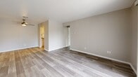 Located at 3550 Woodbridge Drive in Evansville, Indiana, this 1-bedroom, 1-bathroom residence offers a thoughtfully organized single-floor layout comprising a living room, bedroom, kitchen, bathroom, closet, and hallway. Throughout the space, light-toned wood-look flooring and neutral warm-gray walls create a clean, cohesive aesthetic.

The living room is generously proportioned, featuring a large sliding glass door dressed with vertical blinds that invites abundant natural light and provides outdoor views. A separate entry door completes the room, with additional interior doors leading to the kitchen and hallway beyond.

The galley-style kitchen is efficiently designed with white cabinetry, granite-look countertops, a subway tile backsplash, and a full suite of stainless steel appliances including a refrigerator, dishwasher, and range. Light wood-look flooring continues seamlessly throughout.

The bedroom is a comfortable, well-lit space featuring a large double window with horizontal blinds framing greenery outside, and a set of bifold closet doors providing convenient built-in storage. The hallway connects the bedroom directly to the full bathroom, which includes a tub-shower combination and modern fixtures. A dedicated closet provides additional storage within the unit.