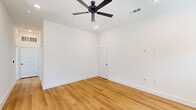 Located at 1600 Firewheel Pkwy in Garland, TX, this clean and contemporary 2-bedroom, 2-bathroom single-story home offers a thoughtfully designed layout with modern finishes throughout. Warm-toned light wood flooring flows continuously across every room, complementing the bright white walls and crisp white baseboards to create a fresh, cohesive aesthetic.

The kitchen is a functional highlight, featuring gray shaker-style cabinetry with matte black hardware, white quartz countertops, a subway tile backsplash, and a full suite of stainless steel appliances including a refrigerator with ice maker, range, and over-the-range microwave. A peninsula provides additional counter space and casual seating potential.

Both bedrooms are generously proportioned, filled with natural light from well-placed windows, and equipped with ceiling fans. The primary bedroom is notably spacious and includes a dedicated closet. Each bedroom benefits from its own bathroom access — one bathroom offers a sleek vanity with a white quartz top and matte black fixtures, while the second features a full tub-shower combination with white tile surround. Both bathrooms continue the home's consistent modern palette of gray cabinetry and black hardware. A hallway and two closets round out the efficient, single-floor floor plan.